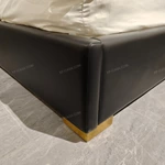 Black Leather Upholstered Bed with Textured Gold Accents, Patterned Quilted Detailing & Brass Hardware Feet